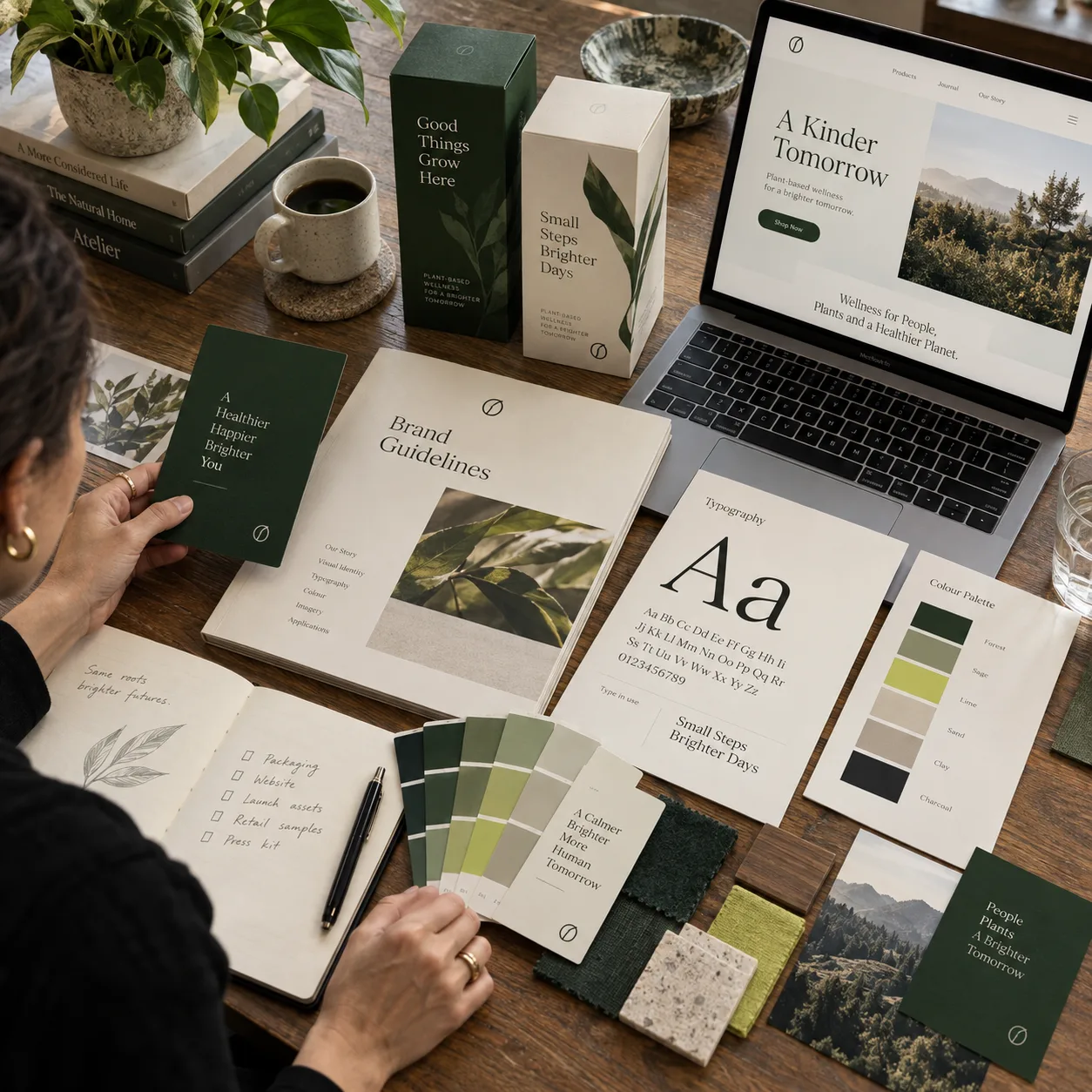 Brand designer reviewing guidelines, packaging, typography, color, and a responsive website